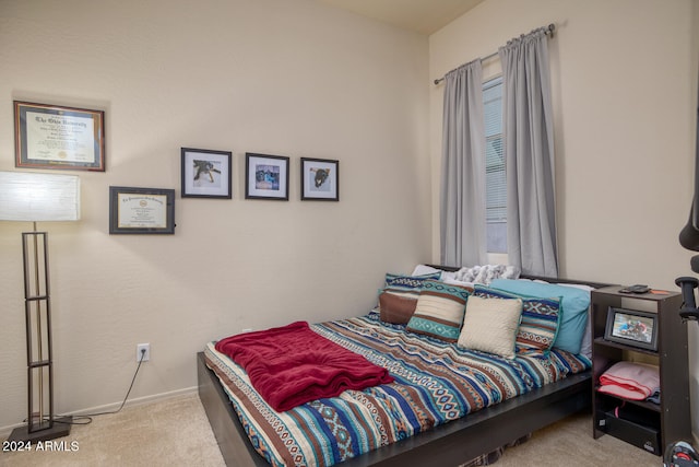 bedroom with light colored carpet