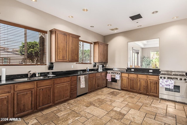 kitchen featuring stainless steel appliances, a wealth of natural light, and sink