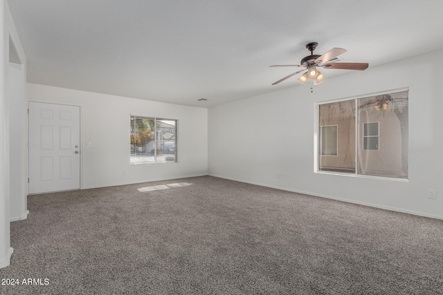 spare room featuring ceiling fan and carpet floors