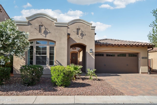 18530 E Mockingbird Ct, Queen Creek, AZ 85142 - mediterranean / spanish home with a tile roof, decorative driveway, an attached garage, and stucco siding
