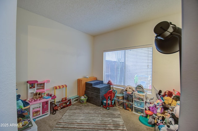 game room featuring carpet and a textured ceiling