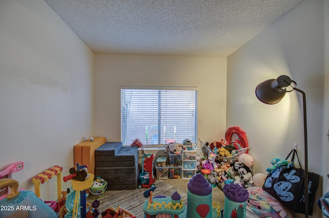 playroom with a textured ceiling