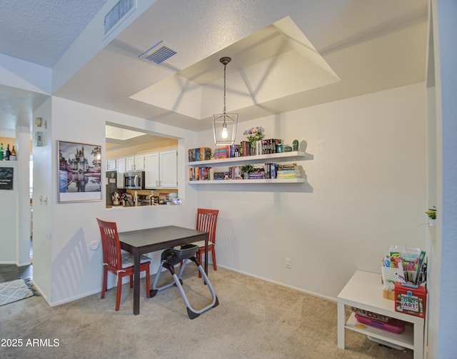 dining area featuring light colored carpet