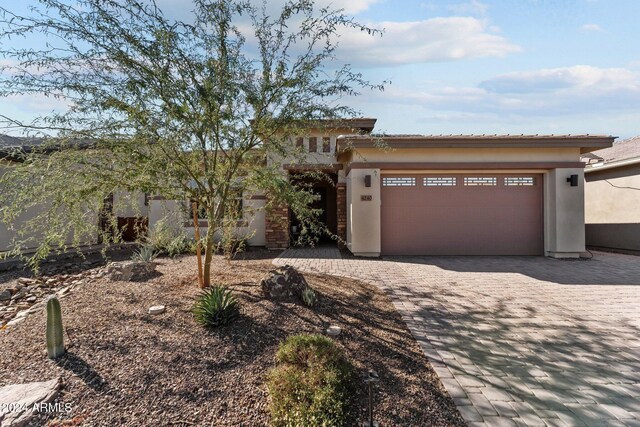 4240 Blacksmith Way, Wickenburg, AZ 85390 - view of front facade with an attached garage, stucco siding, and driveway