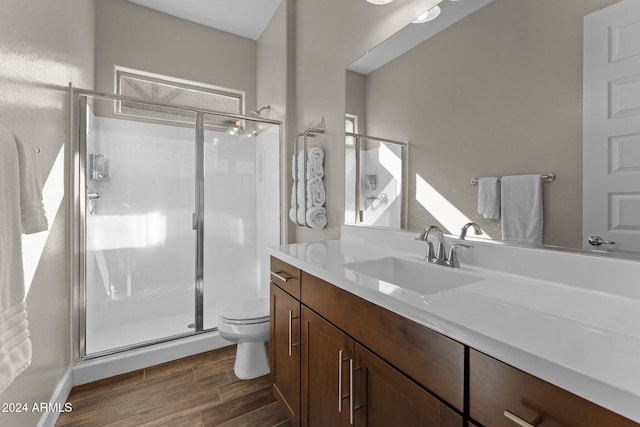 4240 Blacksmith Way, Wickenburg, AZ 85390 - bathroom with wood finished floors, toilet, vanity, and a shower stall