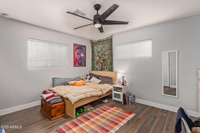 bedroom with ceiling fan and dark hardwood / wood-style flooring