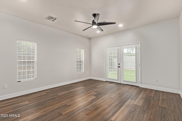 empty room featuring dark hardwood / wood-style flooring, french doors, and ceiling fan