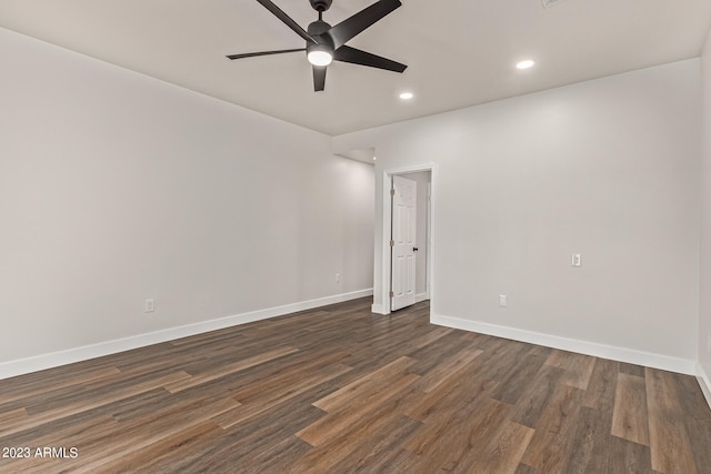 empty room with ceiling fan and dark wood-type flooring