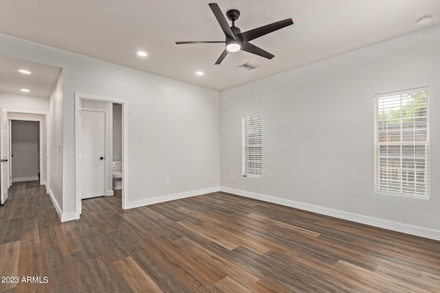 spare room with ceiling fan and dark wood-type flooring