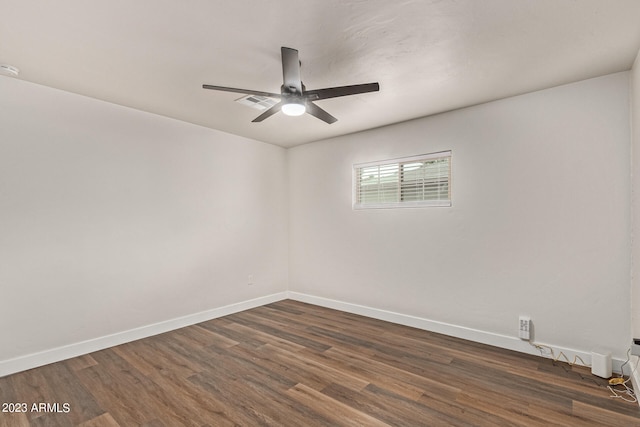 empty room with ceiling fan and dark hardwood / wood-style floors