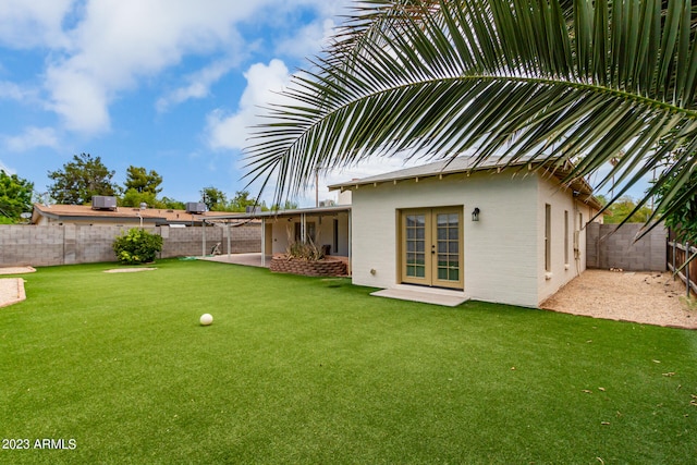 view of yard featuring french doors and a patio