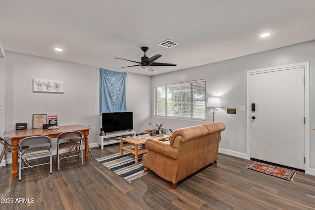 living room featuring dark hardwood / wood-style floors and ceiling fan