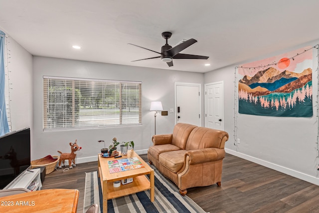 living room with ceiling fan and dark wood-type flooring