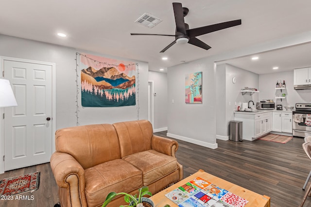 living room with ceiling fan, dark wood-type flooring, and sink