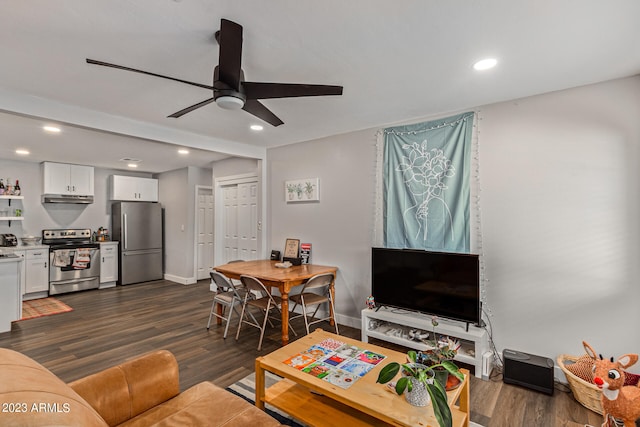 living room featuring dark hardwood / wood-style flooring and ceiling fan