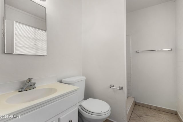 bathroom featuring toilet, a shower, a baseboard heating unit, tile patterned flooring, and vanity