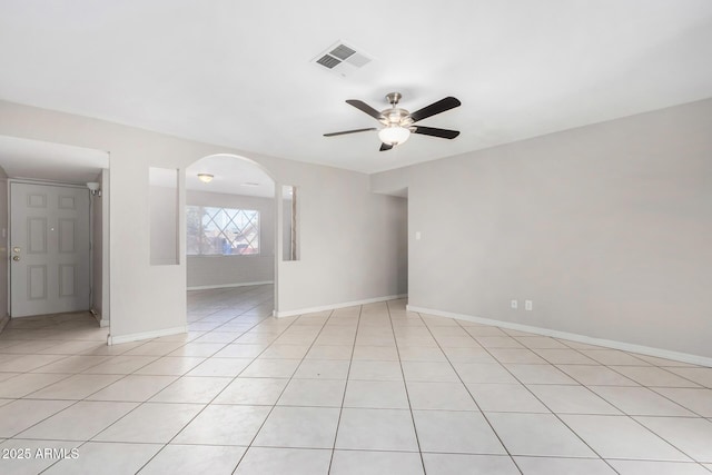 tiled empty room with ceiling fan