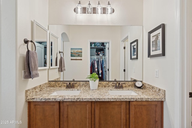 4772 E Portola Valley Dr Unit 102, Gilbert, AZ 85297 - bathroom featuring double vanity and a spacious closet