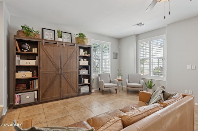 4772 E Portola Valley Dr Unit 102, Gilbert, AZ 85297 - living room featuring baseboards, light tile patterned floors, and ceiling fan
