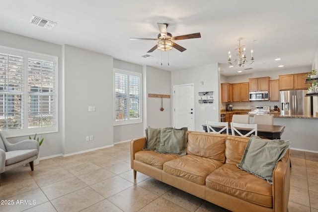 4772 E Portola Valley Dr Unit 102, Gilbert, AZ 85297 - living room with a chandelier, light tile patterned floors, recessed lighting, baseboards, and a ceiling fan