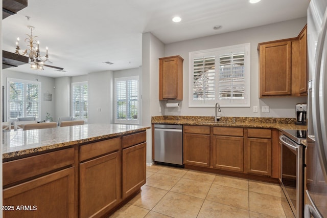4772 E Portola Valley Dr Unit 102, Gilbert, AZ 85297 - kitchen featuring stainless steel appliances, a sink, brown cabinetry, and recessed lighting