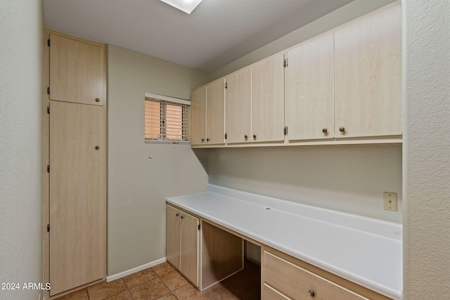 laundry room featuring light tile patterned flooring