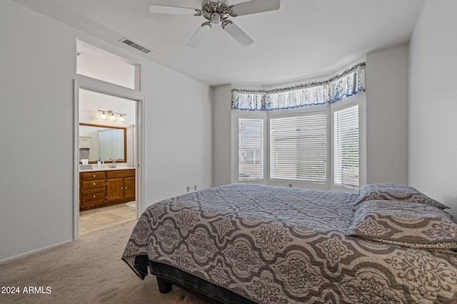 carpeted bedroom featuring sink, ensuite bathroom, and ceiling fan