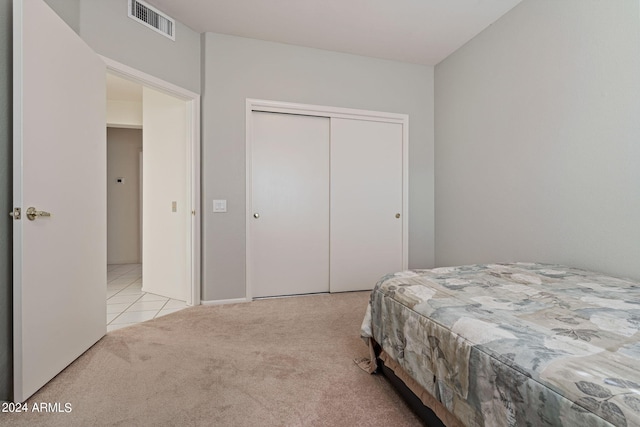 carpeted bedroom with a closet