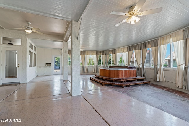 unfurnished sunroom with ceiling fan and plenty of natural light