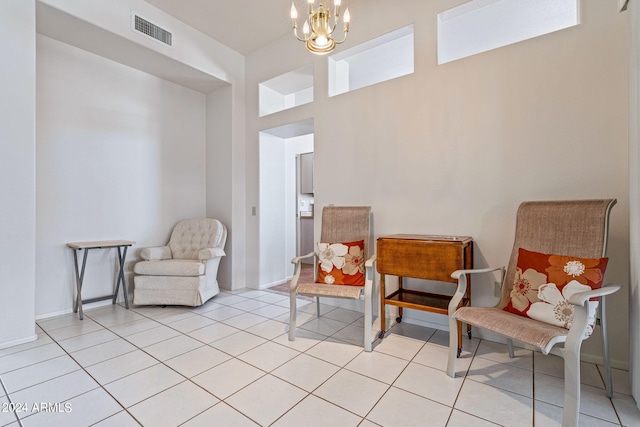 living area with a notable chandelier and light tile patterned flooring