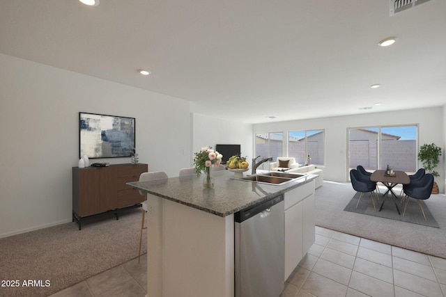 1431 W Tigua Way, Coolidge, AZ 85128 - kitchen with stainless steel dishwasher, light colored carpet, open floor plan, white cabinets, and recessed lighting