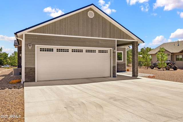 460 S Mountaine Pines Ave, Show Low, AZ 85901 - view of front of house with stone siding, concrete driveway, a garage, and an outbuilding