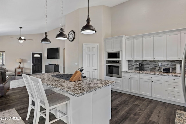 460 S Mountaine Pines Ave, Show Low, AZ 85901 - kitchen with appliances with stainless steel finishes, white cabinets, dark wood-type flooring, open floor plan, and high vaulted ceiling