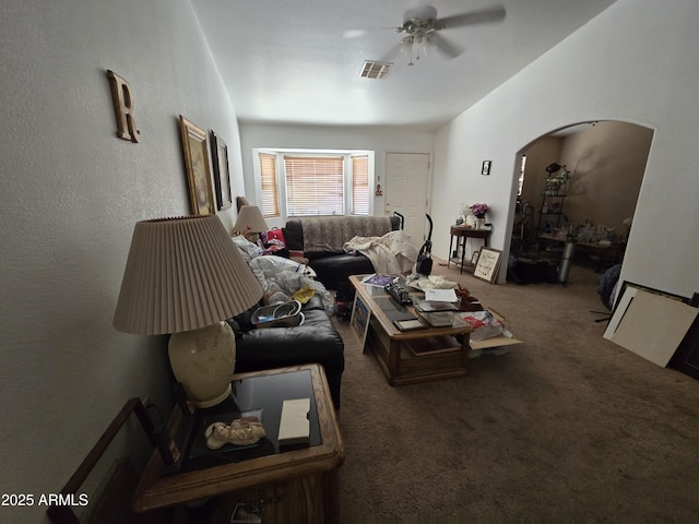 804 W Hess Ave, Coolidge, AZ 85128 - living room with ceiling fan, carpet floors, and arched walkways