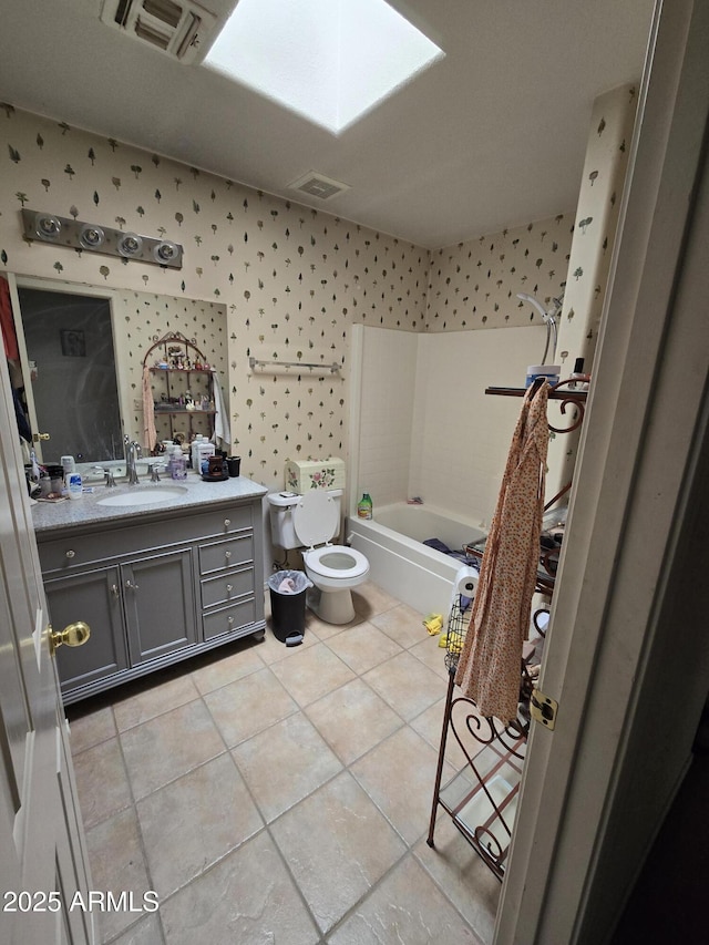 804 W Hess Ave, Coolidge, AZ 85128 - bathroom with vanity, washtub / shower combination, tile patterned flooring, a skylight, and wallpapered walls
