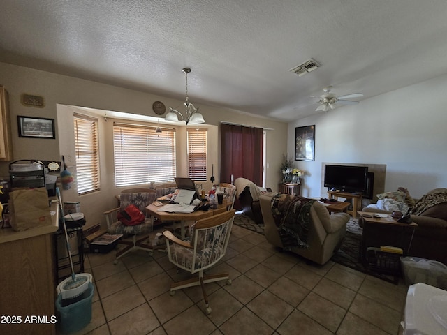 804 W Hess Ave, Coolidge, AZ 85128 - tiled dining space with a chandelier, ceiling fan, and a textured ceiling