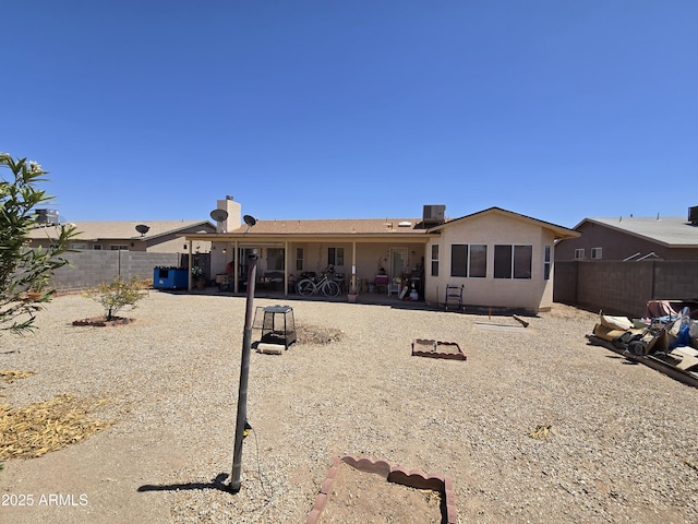 804 W Hess Ave, Coolidge, AZ 85128 - back of property featuring a fenced backyard, a patio area, and a chimney