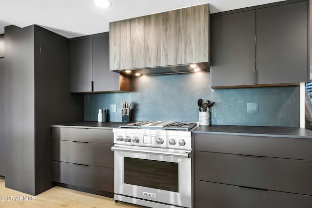 kitchen with dark countertops, gray cabinets, and high end range