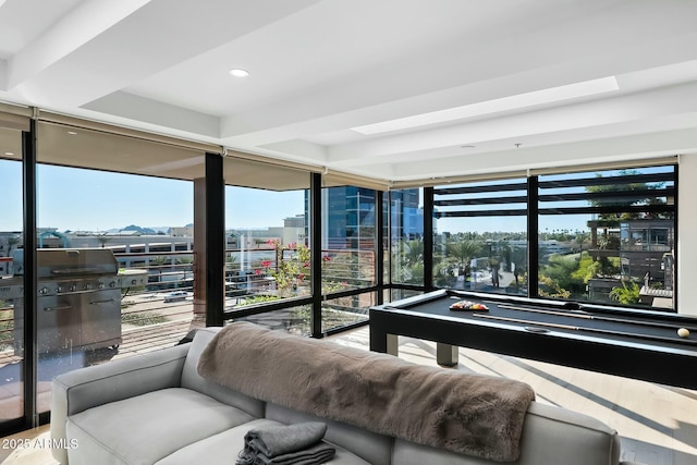 interior space with pool table, a city view, and floor to ceiling windows