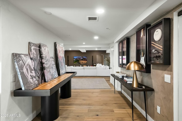 corridor featuring recessed lighting, visible vents, baseboards, and light wood-style floors