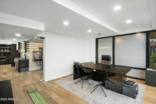 office featuring recessed lighting, wood finished floors, visible vents, and baseboards