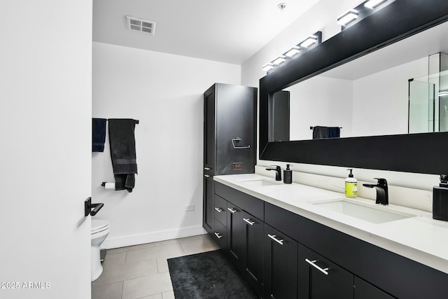 bathroom featuring tile patterned floors, visible vents, toilet, and a sink