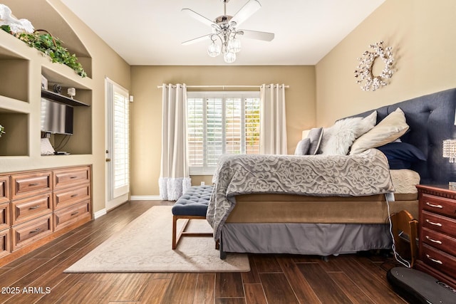 bedroom featuring dark wood-style floors, a ceiling fan, and baseboards