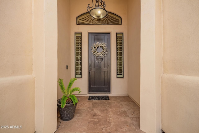 view of exterior entry featuring stucco siding