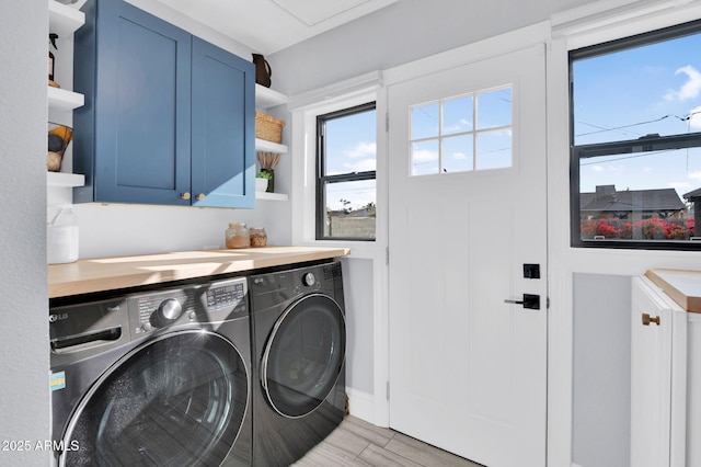 laundry room with cabinets and washer and dryer