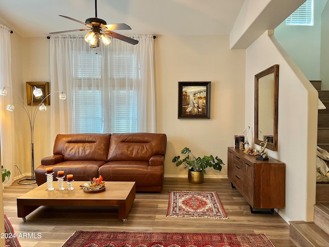 living room with light hardwood / wood-style flooring and ceiling fan