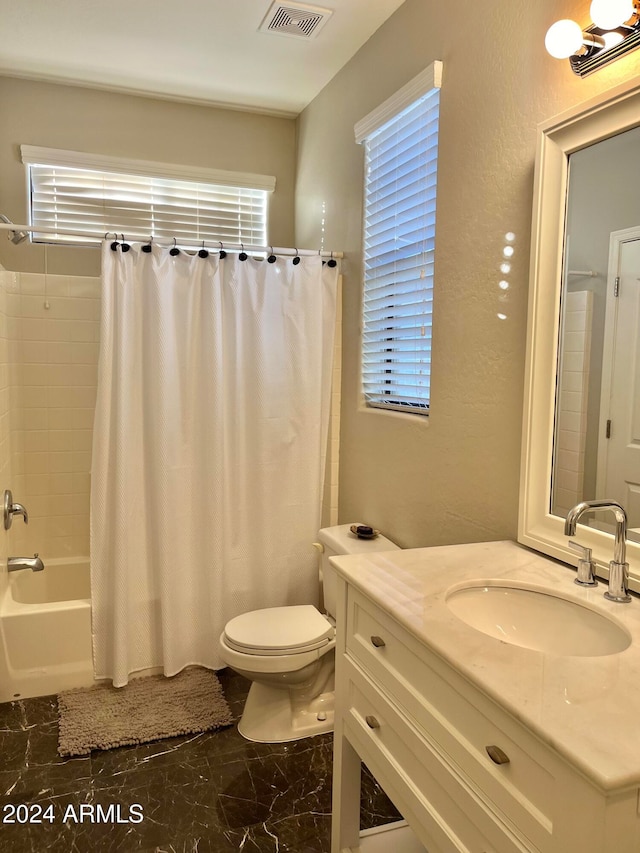 full bathroom with vanity, shower / bath combo with shower curtain, and toilet