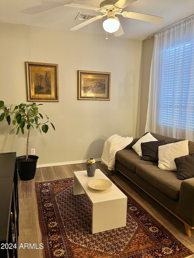 living room featuring hardwood / wood-style flooring and ceiling fan