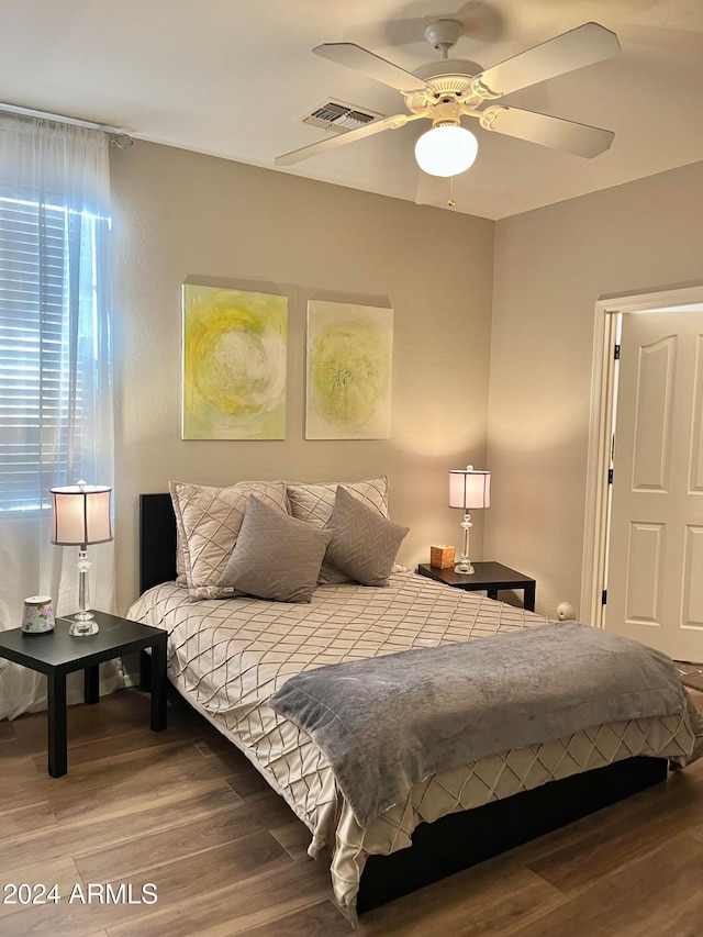 bedroom with hardwood / wood-style flooring and ceiling fan