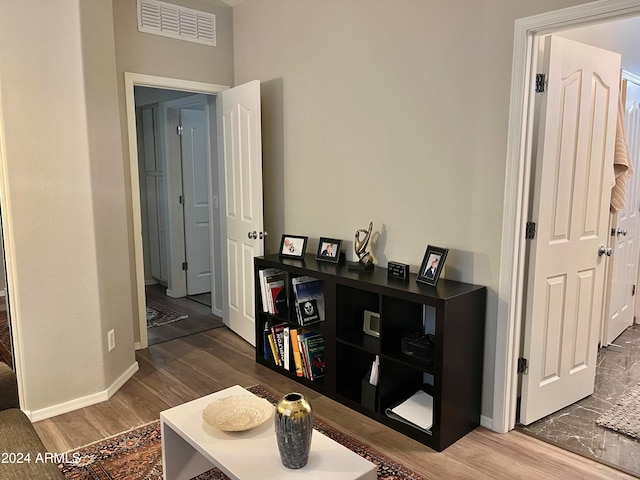 hallway with hardwood / wood-style flooring